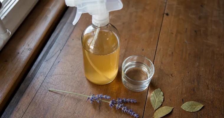 Domowy spray octowy z lawendą i liśćmi laurowymi na blacie kuchennym
